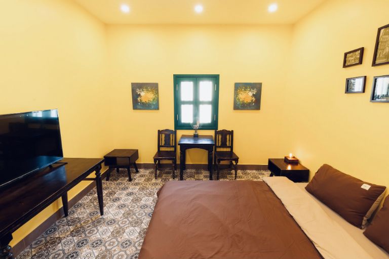 Thiết kế phòng ngủ nổi bật với tông màu sơn vàng và những mảng màu nâu của đồ nội thất, tạo nên một không gian hoài niệm, xưa cũ.