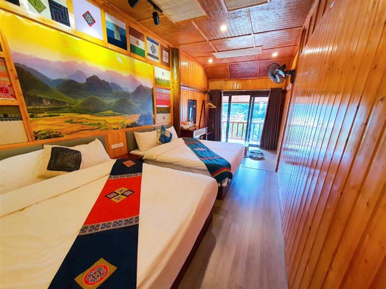 Phòng Family nhà sàn tại Đồng Văn CliffSide House gây ấn tượng với tường và sàn nhà lát gỗ mang lại cảm giác ấm cúng và sang trọng. 