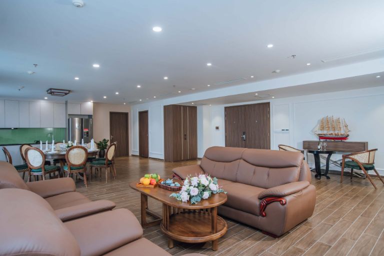 Phòng khách tại Suite Tổng Thống có thiết kế vô cùng sang trọng với bộ sofa cao cấp, bên cạnh đó là khu vực bếp có bàn ăn rộng lớn phục vụ mọi nhu cầu của du khách. 
