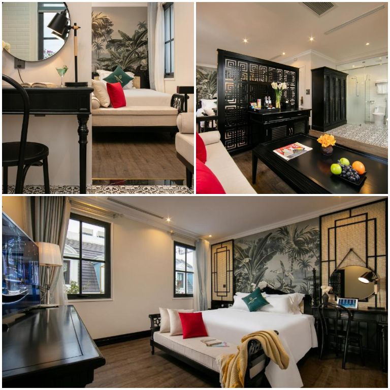 Phòng Family Suite sở hữu không gian sang trọng với nền lát gỗ vân kết hợp nội thất gỗ đen và tranh nghệ thuật thẩm mỹ. 